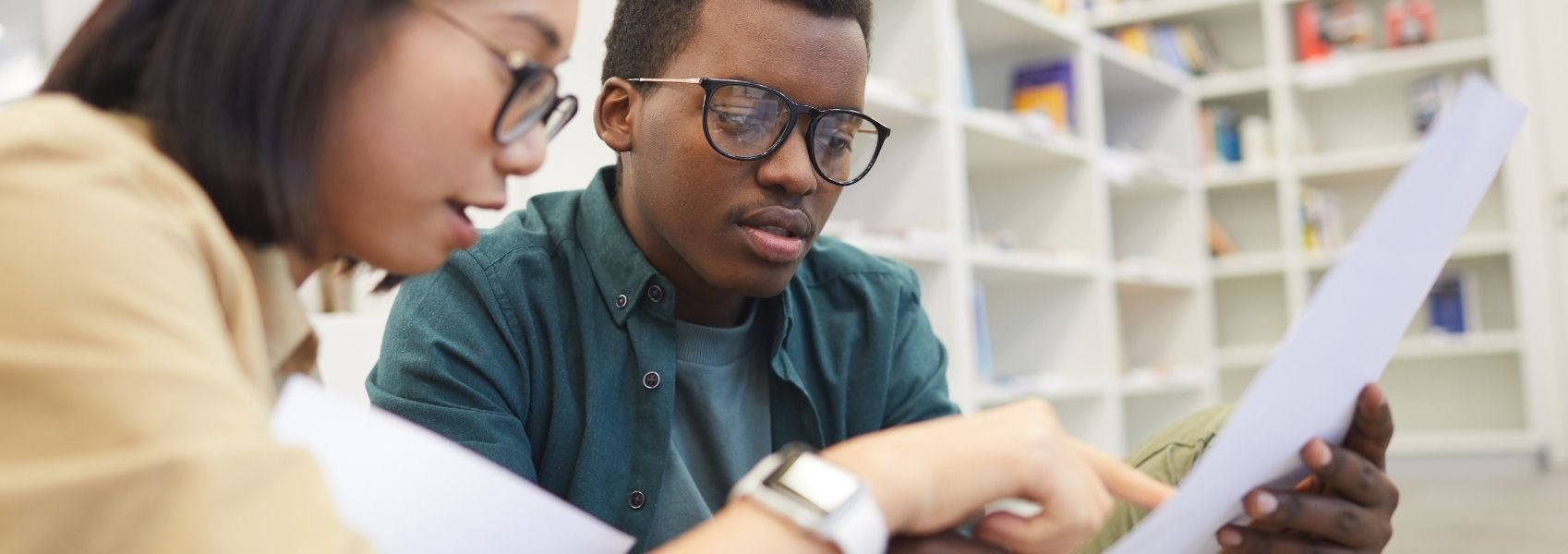 Students looking at paper